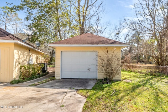 detached garage featuring concrete driveway