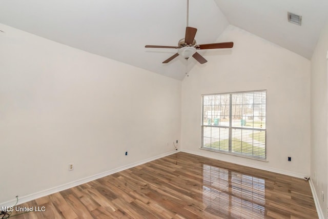 spare room featuring high vaulted ceiling, wood finished floors, visible vents, and baseboards