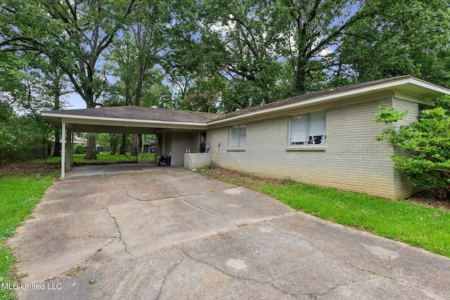 3443 Marguerite Dr, Pearl, MS 39208 - view of front of home featuring concrete driveway, brick siding, and a carport
