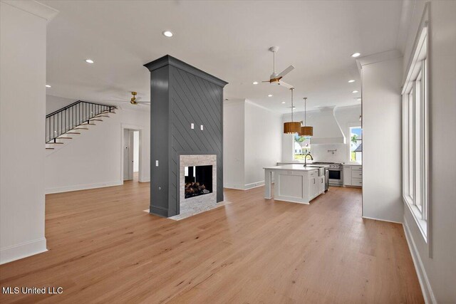 462 Whittington Cir, Madison, MS 39110 - unfurnished living room featuring a multi sided fireplace, recessed lighting, ceiling fan, and light wood-type flooring