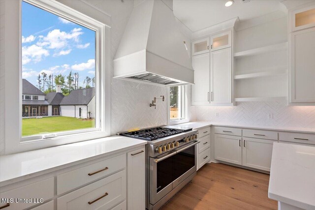 462 Whittington Cir, Madison, MS 39110 - kitchen featuring open shelves, range with two ovens, white cabinetry, light wood-type flooring, and custom exhaust hood