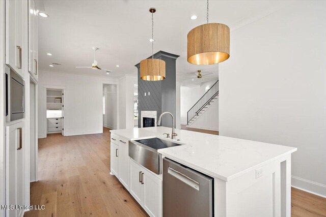 462 Whittington Cir, Madison, MS 39110 - kitchen featuring ceiling fan, stainless steel dishwasher, a sink, open floor plan, and white cabinetry