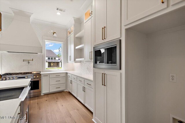 462 Whittington Cir, Madison, MS 39110 - kitchen with white cabinets, open shelves, appliances with stainless steel finishes, light wood-style floors, and decorative backsplash