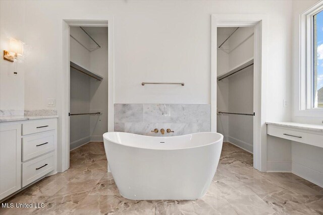 462 Whittington Cir, Madison, MS 39110 - bathroom featuring vanity, marble finish floor, plenty of natural light, and a freestanding tub