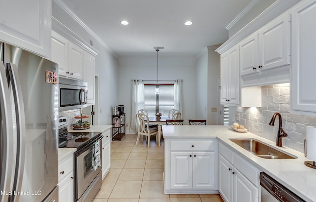 kitchen with pendant lighting, white cabinetry, and stainless steel appliances