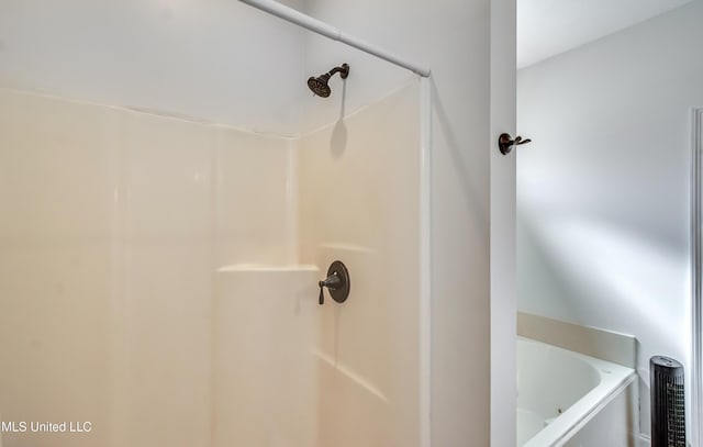 bathroom featuring shower with separate bathtub