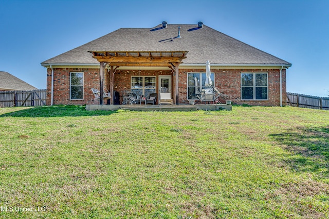 rear view of house featuring a patio and a lawn