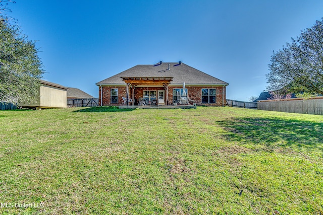 rear view of property with a pergola and a lawn