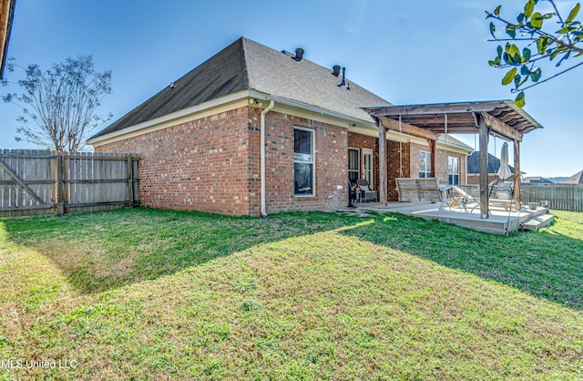 back of property with a patio and a lawn