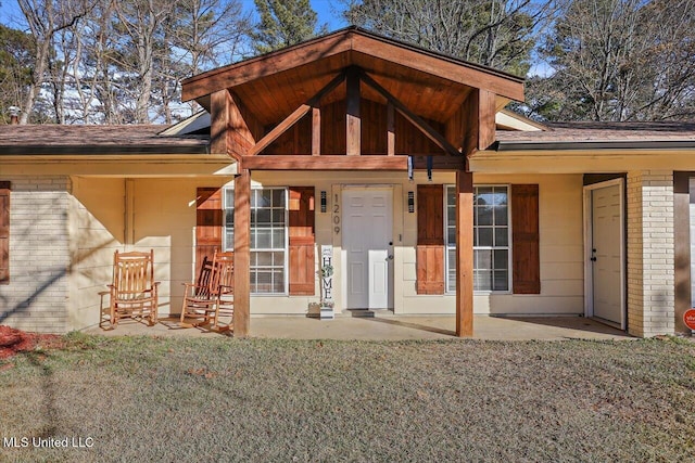 rear view of property featuring a lawn