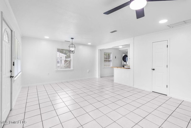 unfurnished living room with crown molding, ceiling fan, and light tile patterned floors