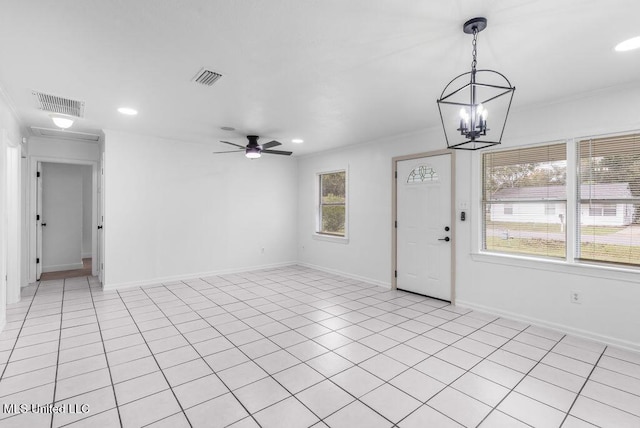 interior space with ceiling fan with notable chandelier