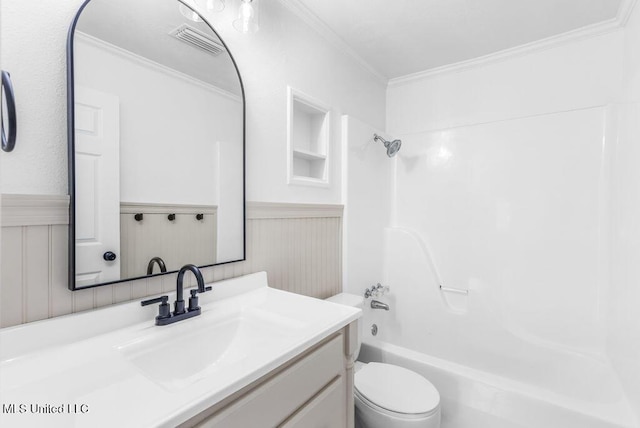 full bathroom featuring vanity, ornamental molding, shower / bathtub combination, and toilet