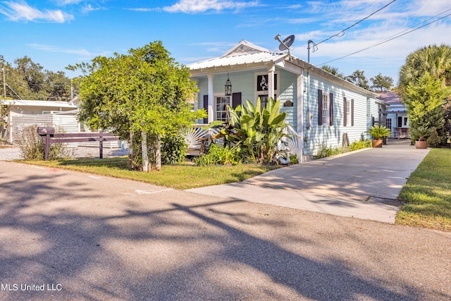 253 Sycamore St, Bay Saint Louis, MS 39520 - view of front of property with fence, covered porch, and concrete driveway