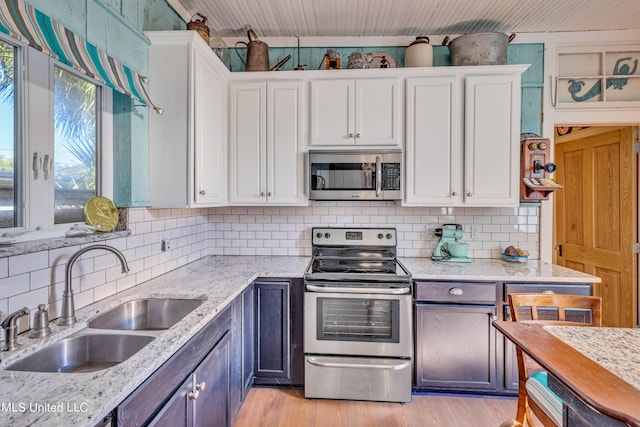253 Sycamore St, Bay Saint Louis, MS 39520 - kitchen with a sink, stainless steel appliances, and white cabinetry