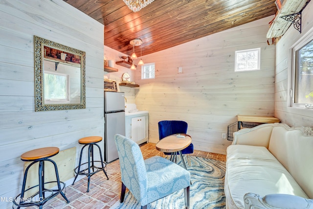 living room featuring lofted ceiling, wooden walls, and wooden ceiling