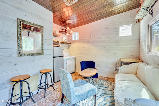 253 Sycamore St, Bay Saint Louis, MS 39520 - living room with wood ceiling, brick floor, vaulted ceiling, and wood walls