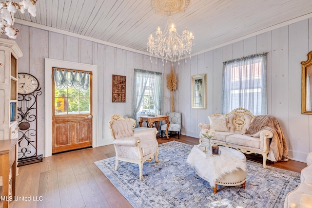 living area with crown molding, hardwood / wood-style flooring, wooden walls, and wooden ceiling