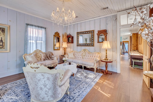 living room with wood ceiling, wood walls, wood-type flooring, and crown molding