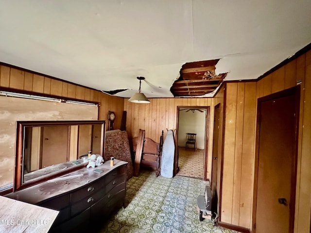 bedroom featuring wood walls and light floors
