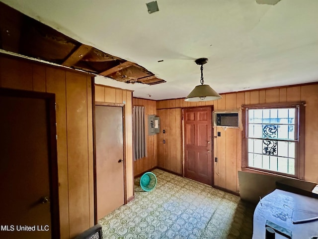 foyer featuring electric panel, tile patterned floors, an AC wall unit, and wooden walls
