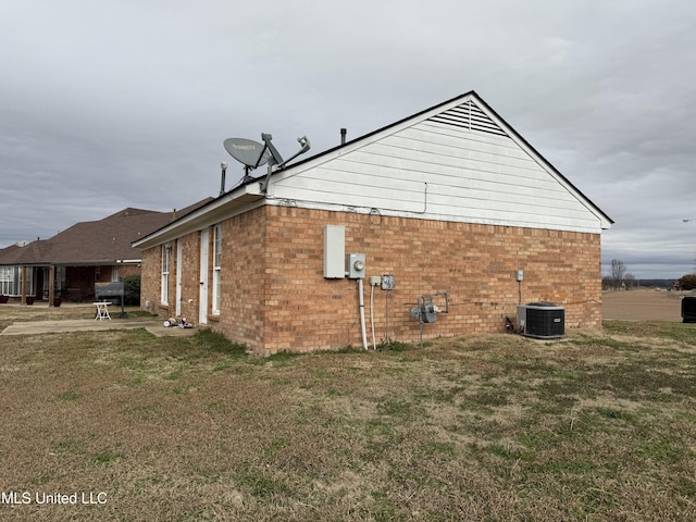 view of home's exterior featuring central AC and a lawn