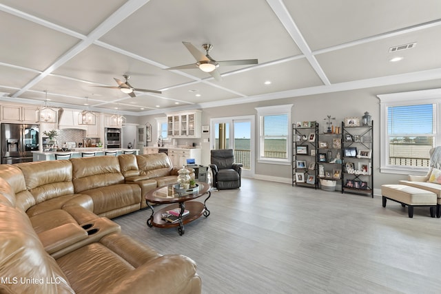 living room featuring ceiling fan, coffered ceiling, and light wood-type flooring