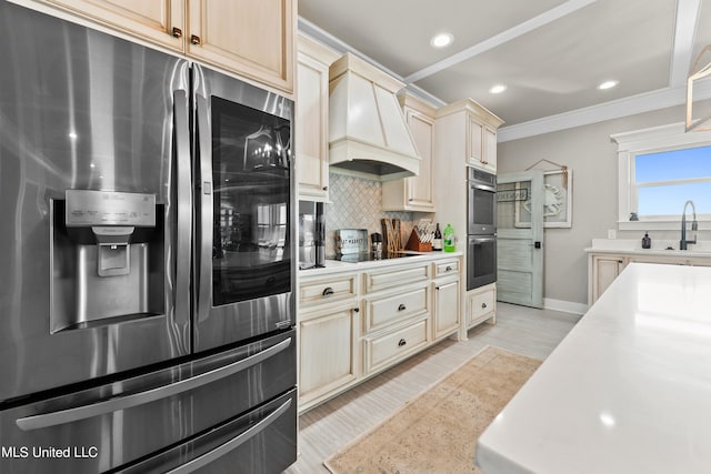 kitchen with stainless steel appliances, backsplash, ornamental molding, light wood-type flooring, and premium range hood