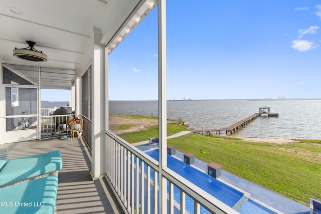 exterior space with a water view and ceiling fan