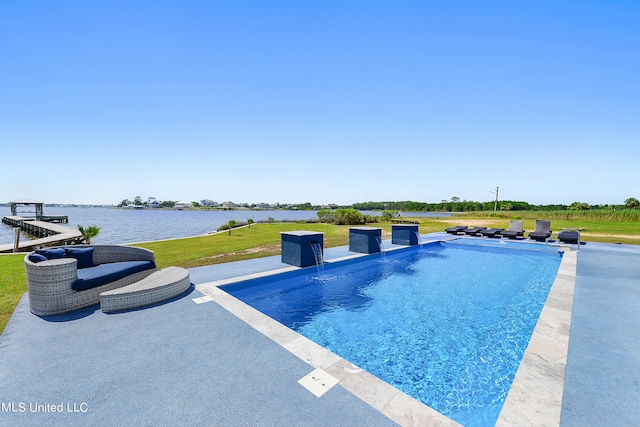 view of pool with a patio area, a yard, and a water view