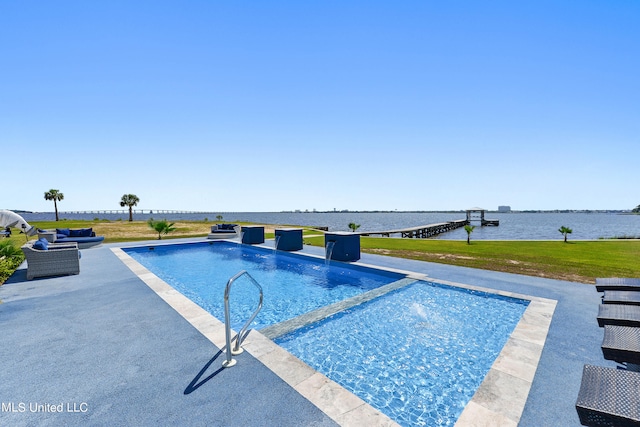 view of swimming pool featuring a water view, a patio, pool water feature, and a lawn