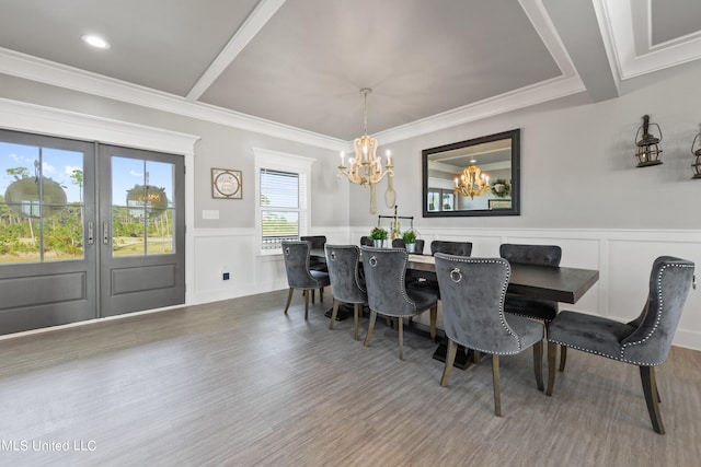 dining room with ornamental molding, french doors, and hardwood / wood-style floors