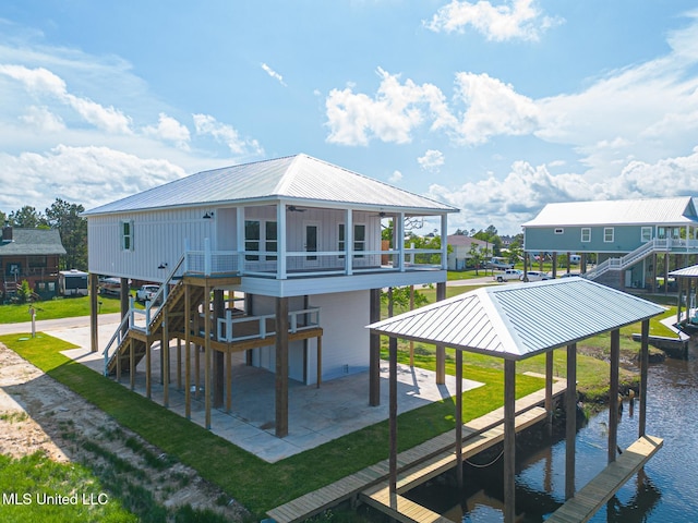 4054 Mallard St, Bay Saint Louis, MS 39520 - back of property with stairs, a water view, a ceiling fan, a lawn, and board and batten siding
