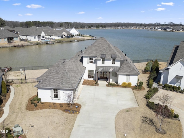 drone / aerial view with a water view and a residential view