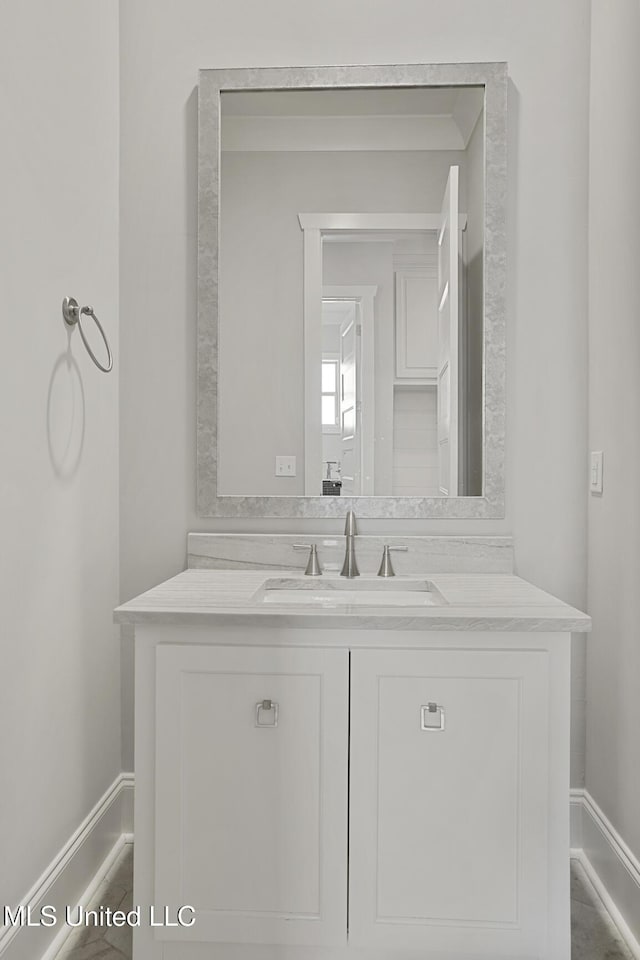 bathroom featuring vanity and baseboards