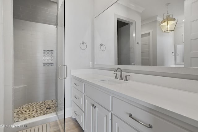 full bath featuring a shower stall, vanity, and wood finished floors