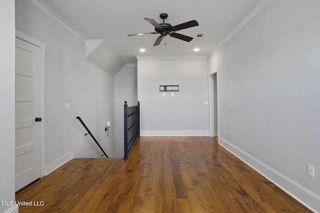 corridor with visible vents, an upstairs landing, baseboards, ornamental molding, and wood-type flooring