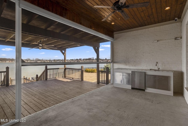 wooden deck featuring a water view, ceiling fan, and area for grilling