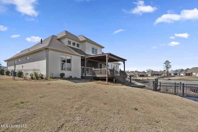 back of property featuring a fenced backyard, brick siding, a lawn, and roof with shingles