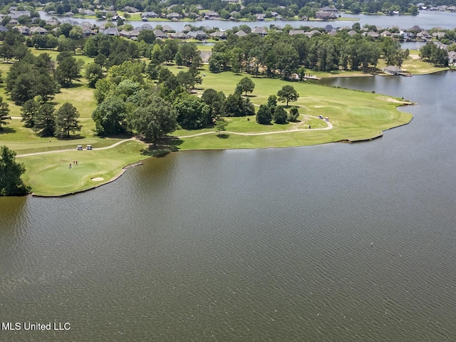 drone / aerial view featuring golf course view and a water view