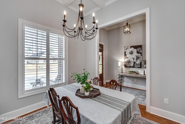 dining space featuring crown molding, hardwood / wood-style flooring, a chandelier, and a healthy amount of sunlight