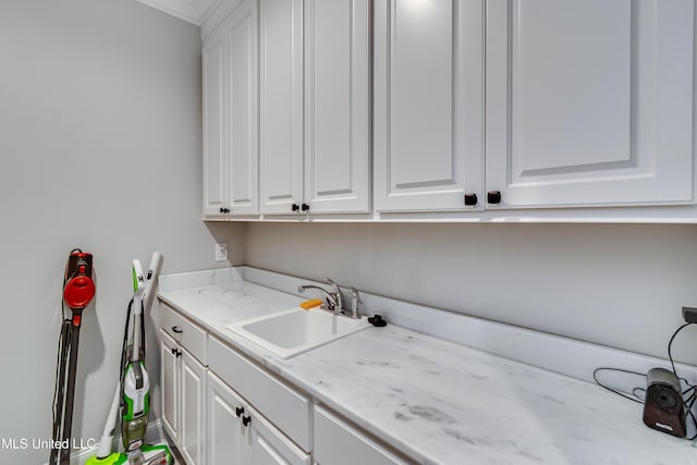 clothes washing area featuring sink