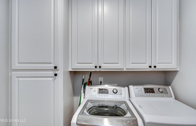 laundry area with cabinets and independent washer and dryer