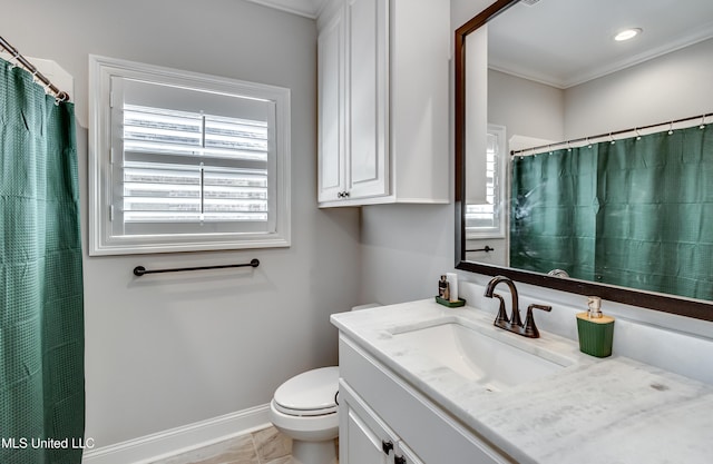 bathroom with vanity, ornamental molding, and toilet