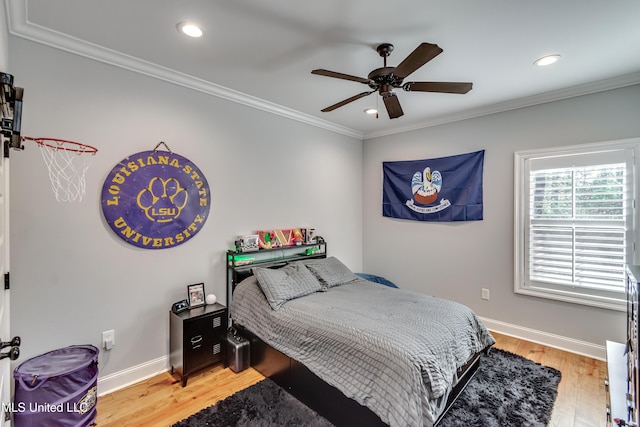 bedroom with wood-type flooring, ornamental molding, and ceiling fan