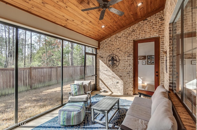 sunroom featuring vaulted ceiling, wooden ceiling, and ceiling fan