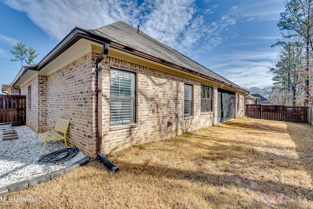 view of side of home featuring a lawn