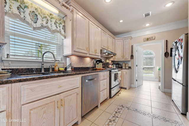 12441 Old Cypress Creek Cv, Diberville, MS 39540 - kitchen featuring stainless steel appliances, light brown cabinetry, light tile patterned floors, tasteful backsplash, and ornamental molding