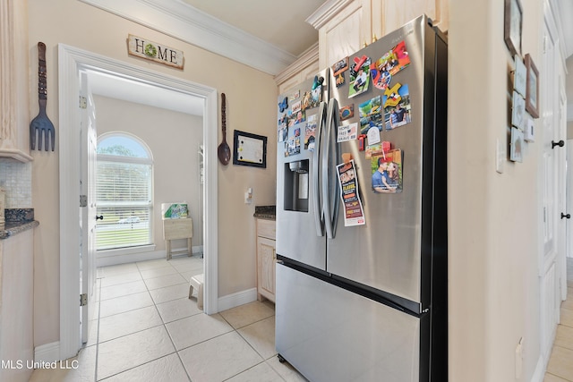 12441 Old Cypress Creek Cv, Diberville, MS 39540 - kitchen featuring stainless steel fridge with ice dispenser, ornamental molding, light tile patterned floors, and dark stone countertops