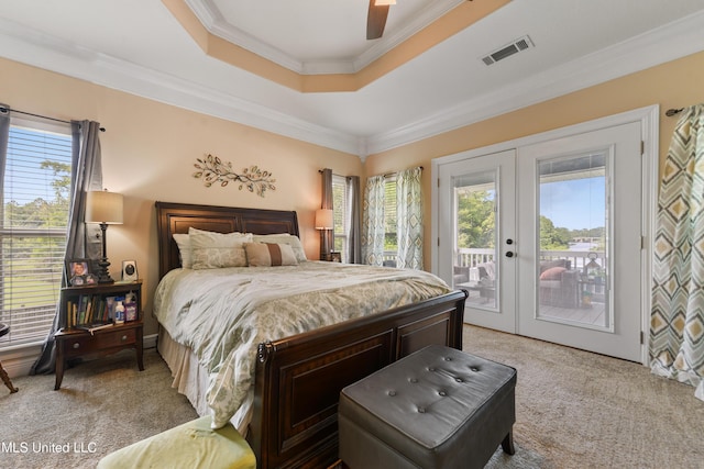 12441 Old Cypress Creek Cv, Diberville, MS 39540 - bedroom with light colored carpet, a tray ceiling, french doors, crown molding, and access to exterior